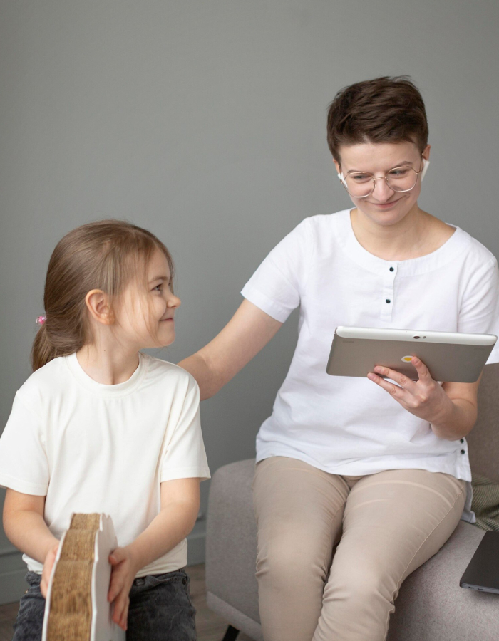 ADHD assessment session with a child and healthcare professional discussing activities on a tablet