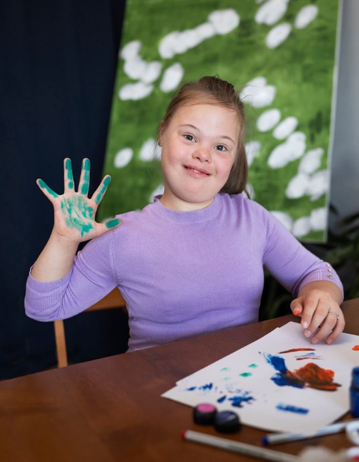 Child with Down syndrome participating in a creative activity during a developmental assessment