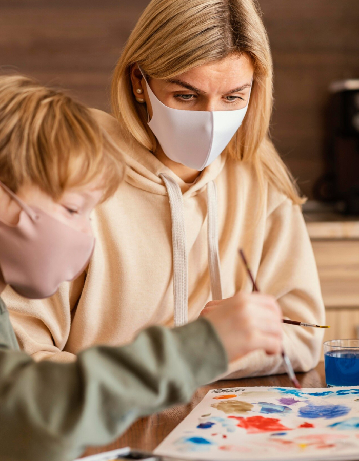 Parent and child wearing face masks during an ADHD assessment activity at home