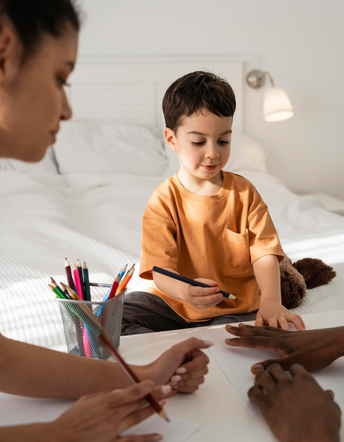Parent supporting a child during a behavioural assessment and learning activity at home
