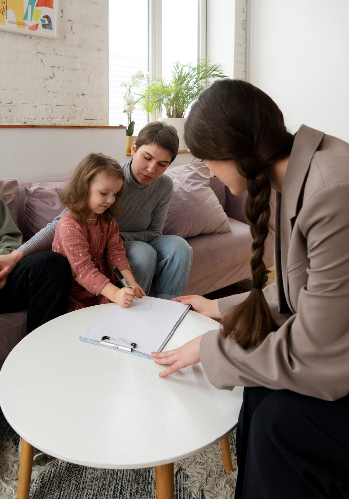 Child completing a learning activity with parents during an ADHD evaluation session