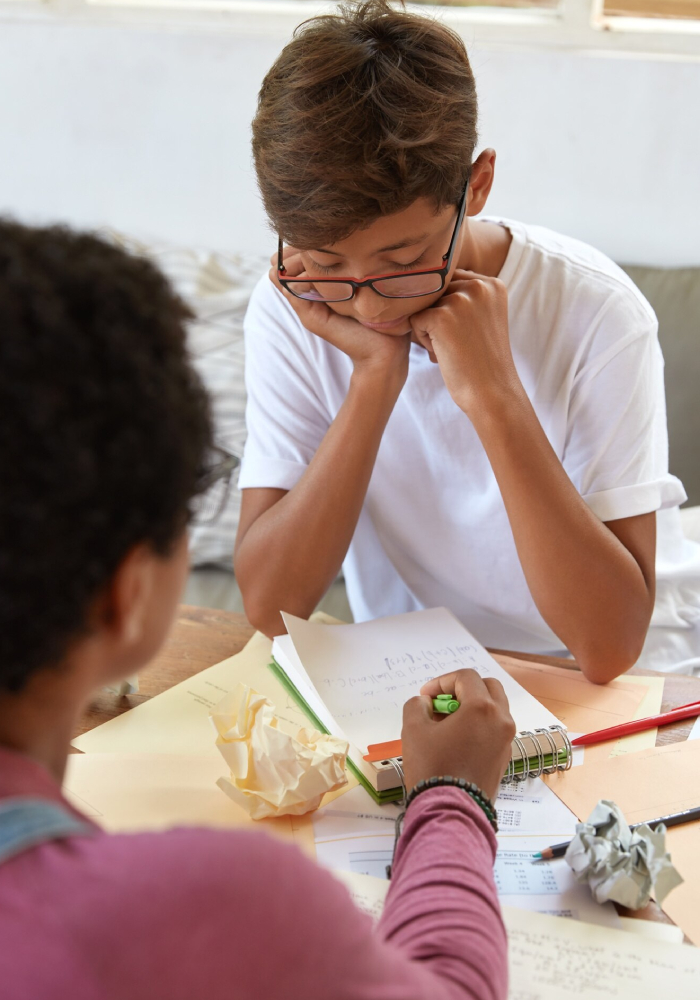 Child receiving support from an educator during a learning disorder assessment session